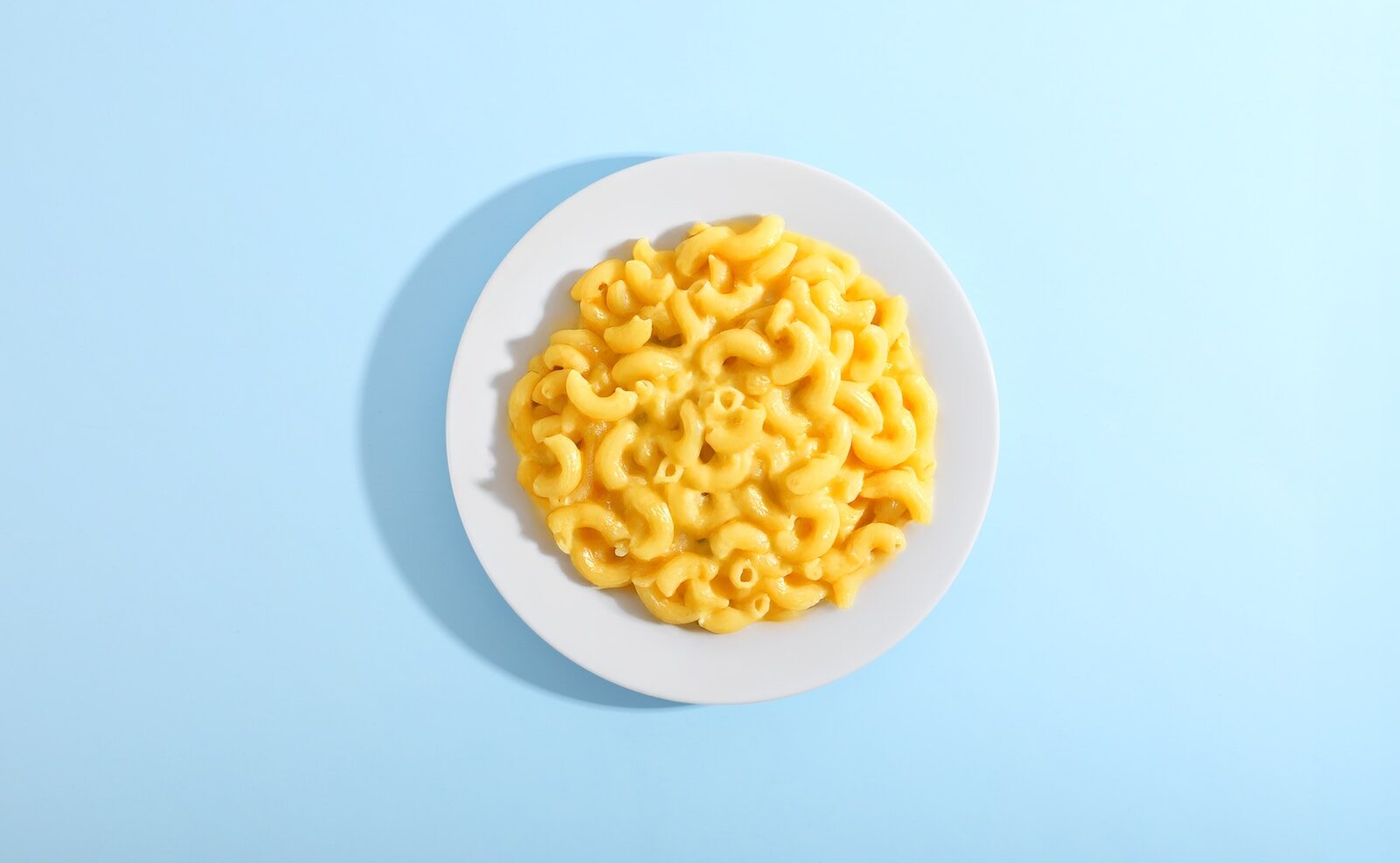 Mac and cheese served on a white plate.